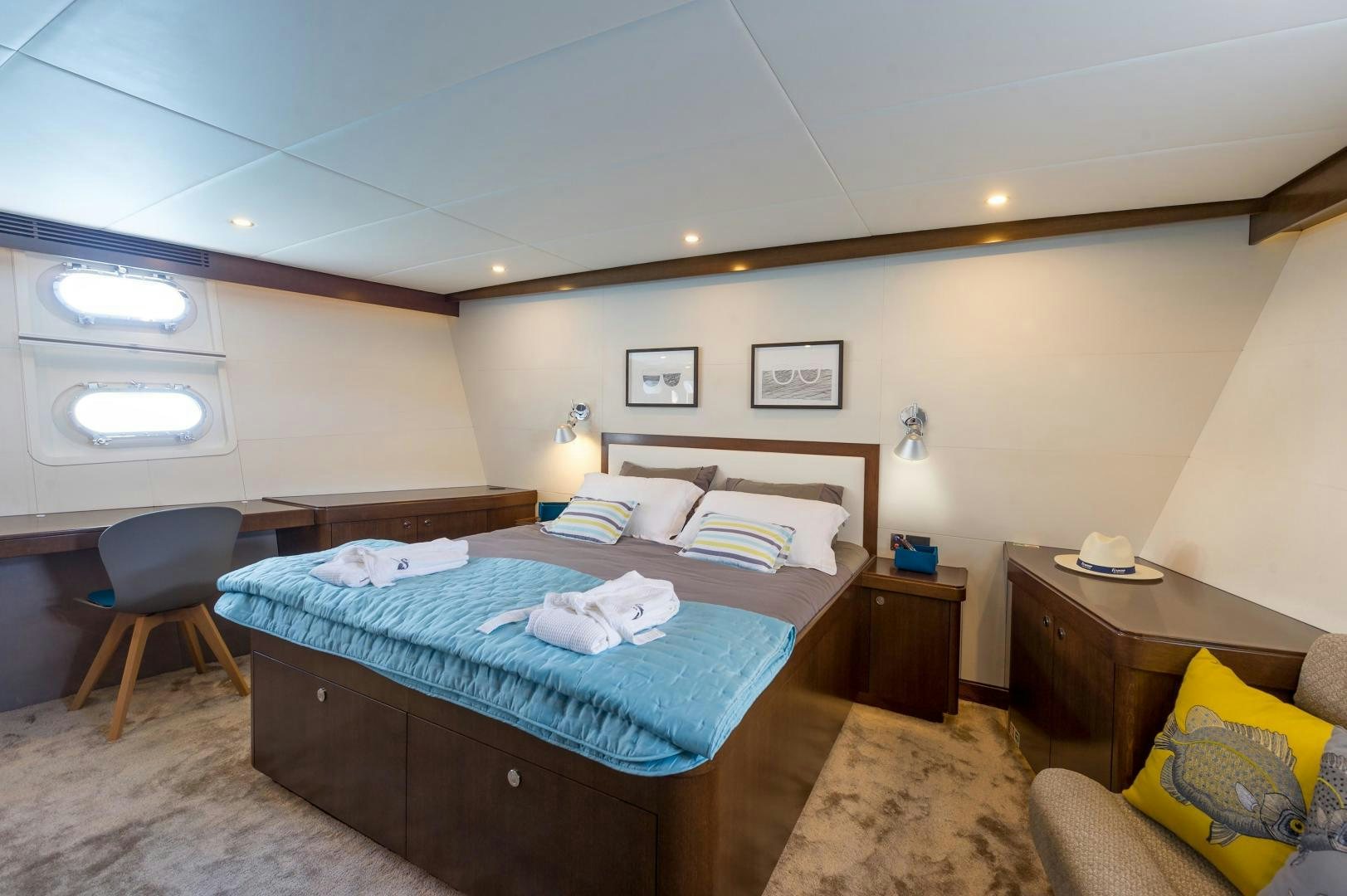 a bedroom with a bed and a desk aboard MONARA Yacht for Sale