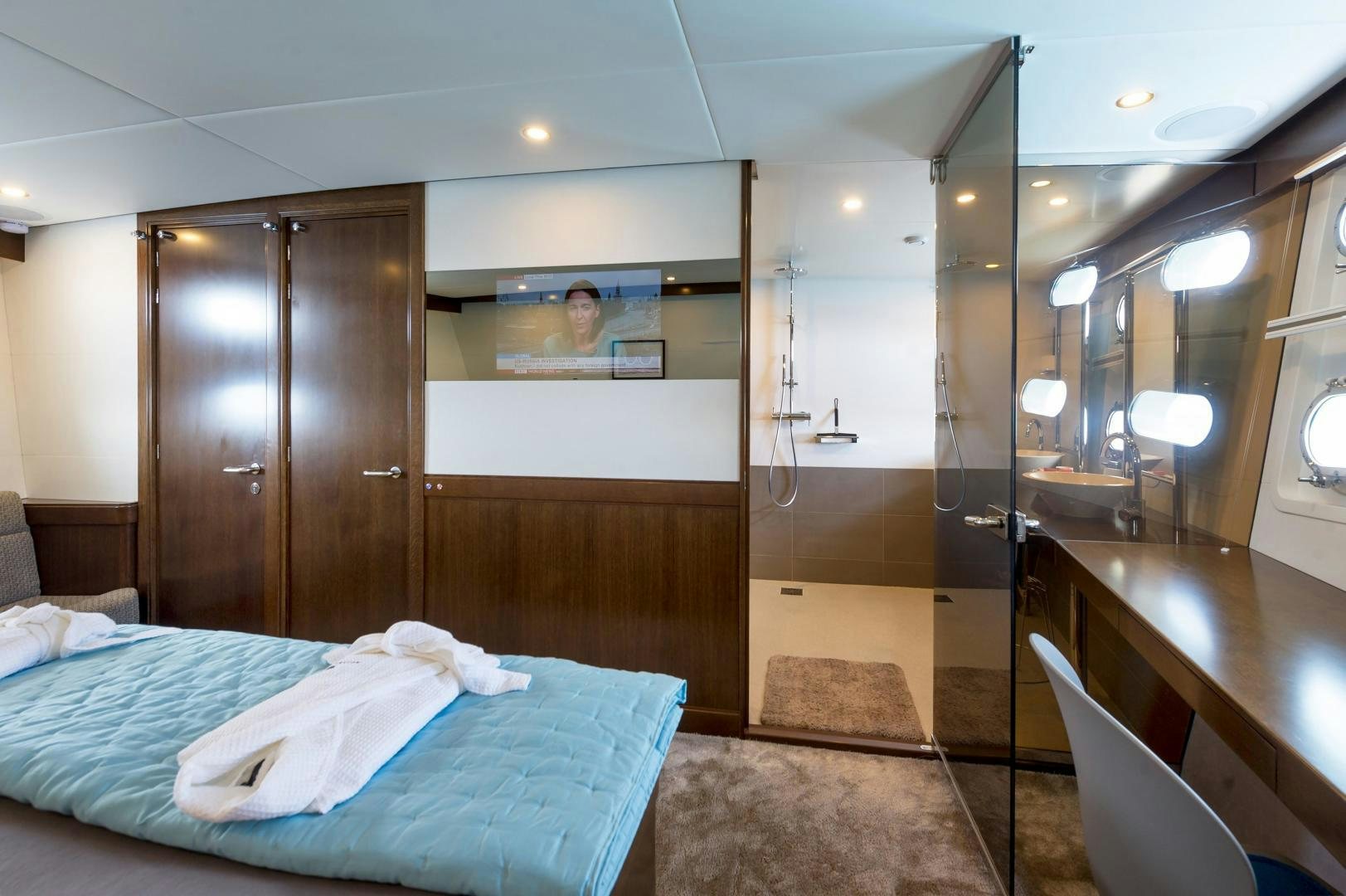a hotel room with a bed and a mirror aboard MONARA Yacht for Sale