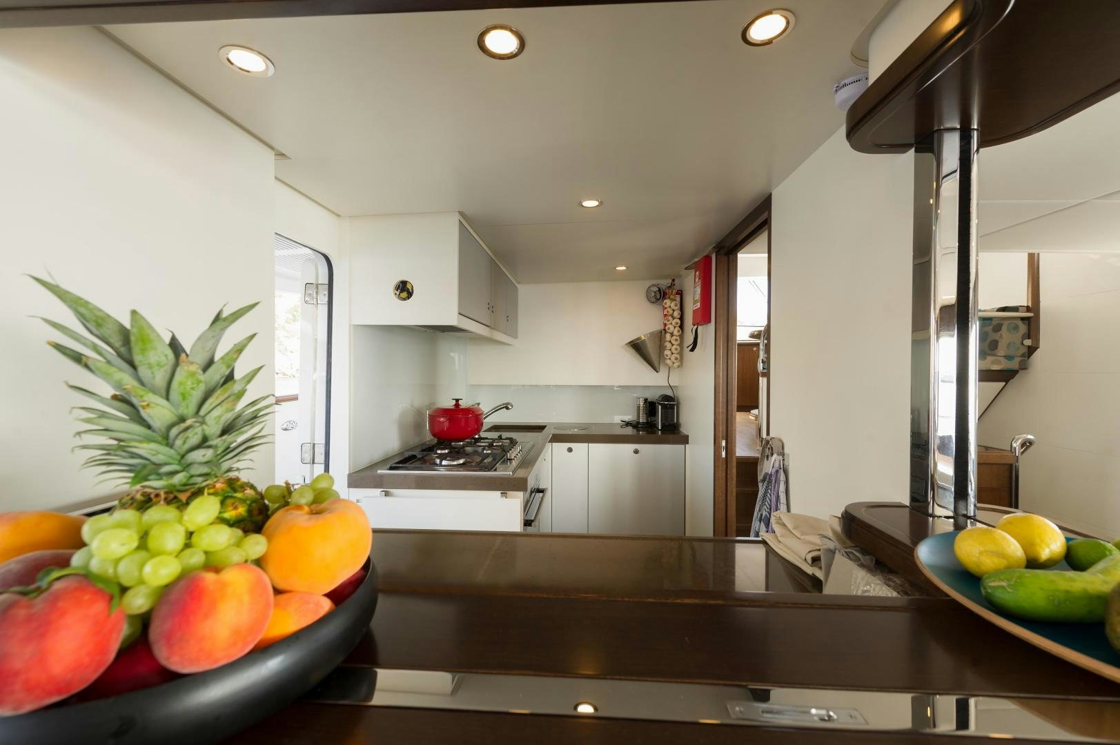 a kitchen with a bowl of fruit aboard MONARA Yacht for Sale