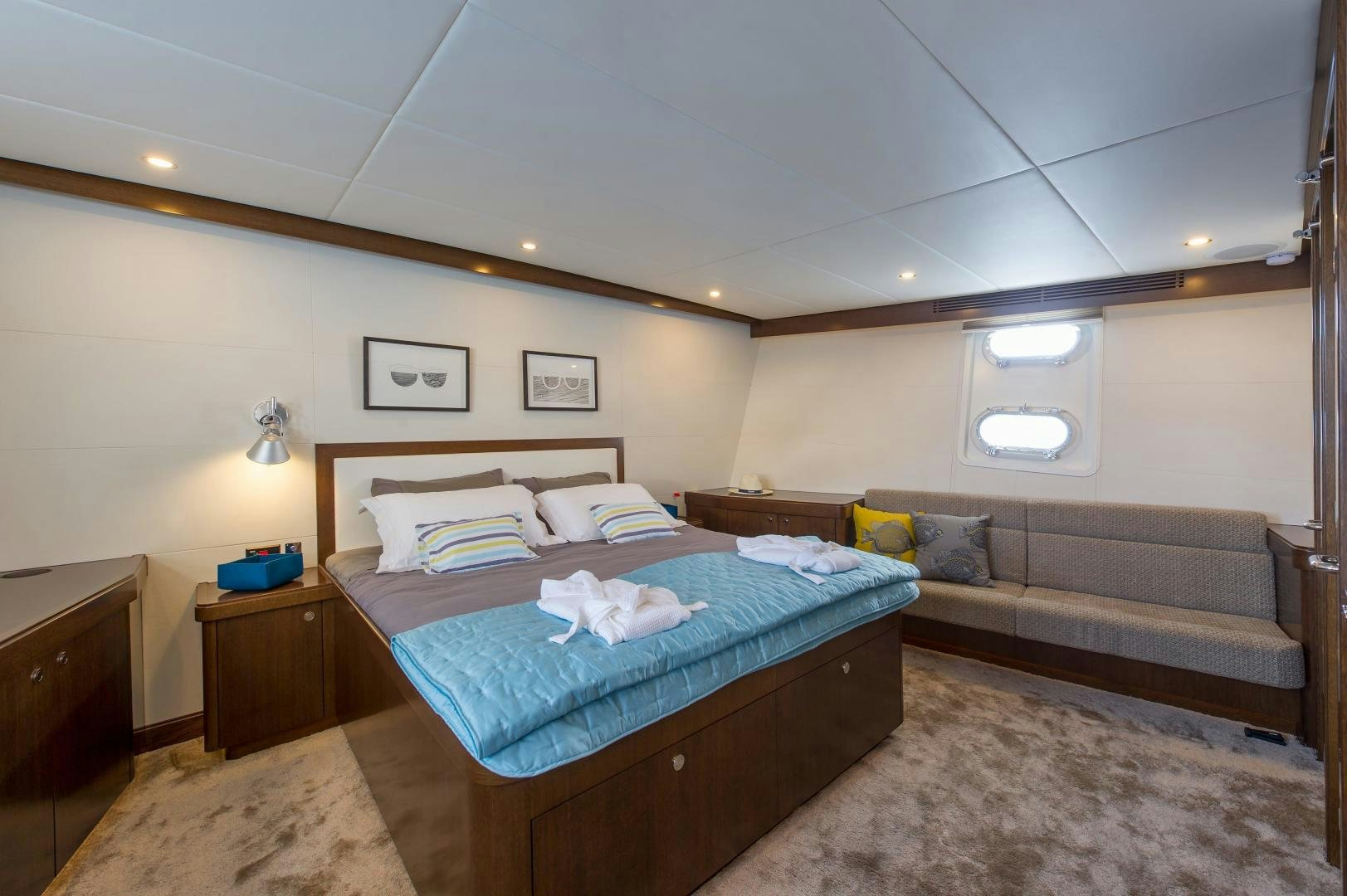 a bedroom with a bed and a couch aboard MONARA Yacht for Sale