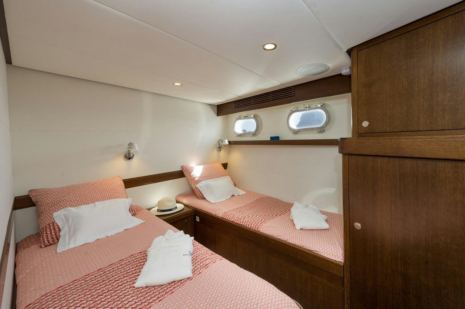 a couple of beds in a hotel room aboard MONARA Yacht for Sale