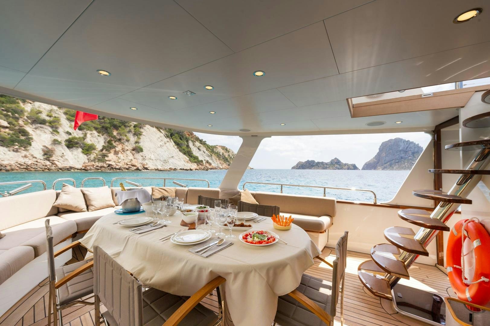 a room with tables and chairs aboard MONARA Yacht for Sale