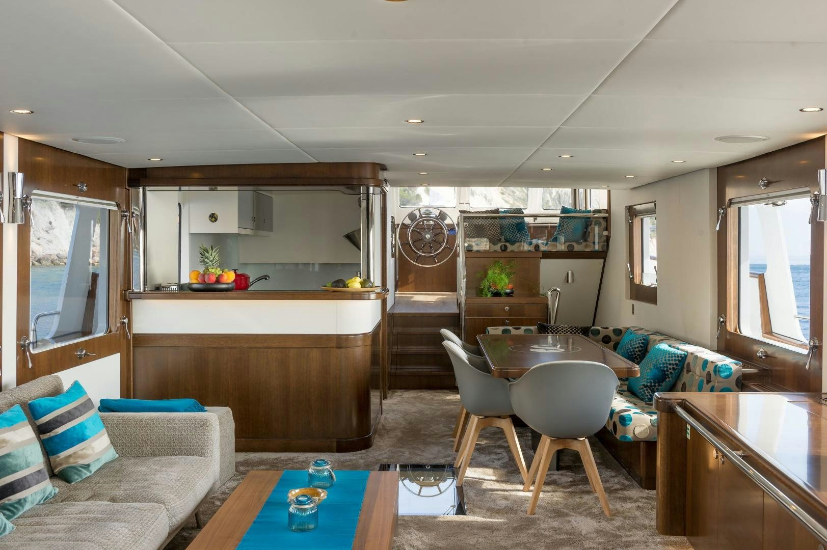 a living room with a kitchen and dining area aboard MONARA Yacht for Sale