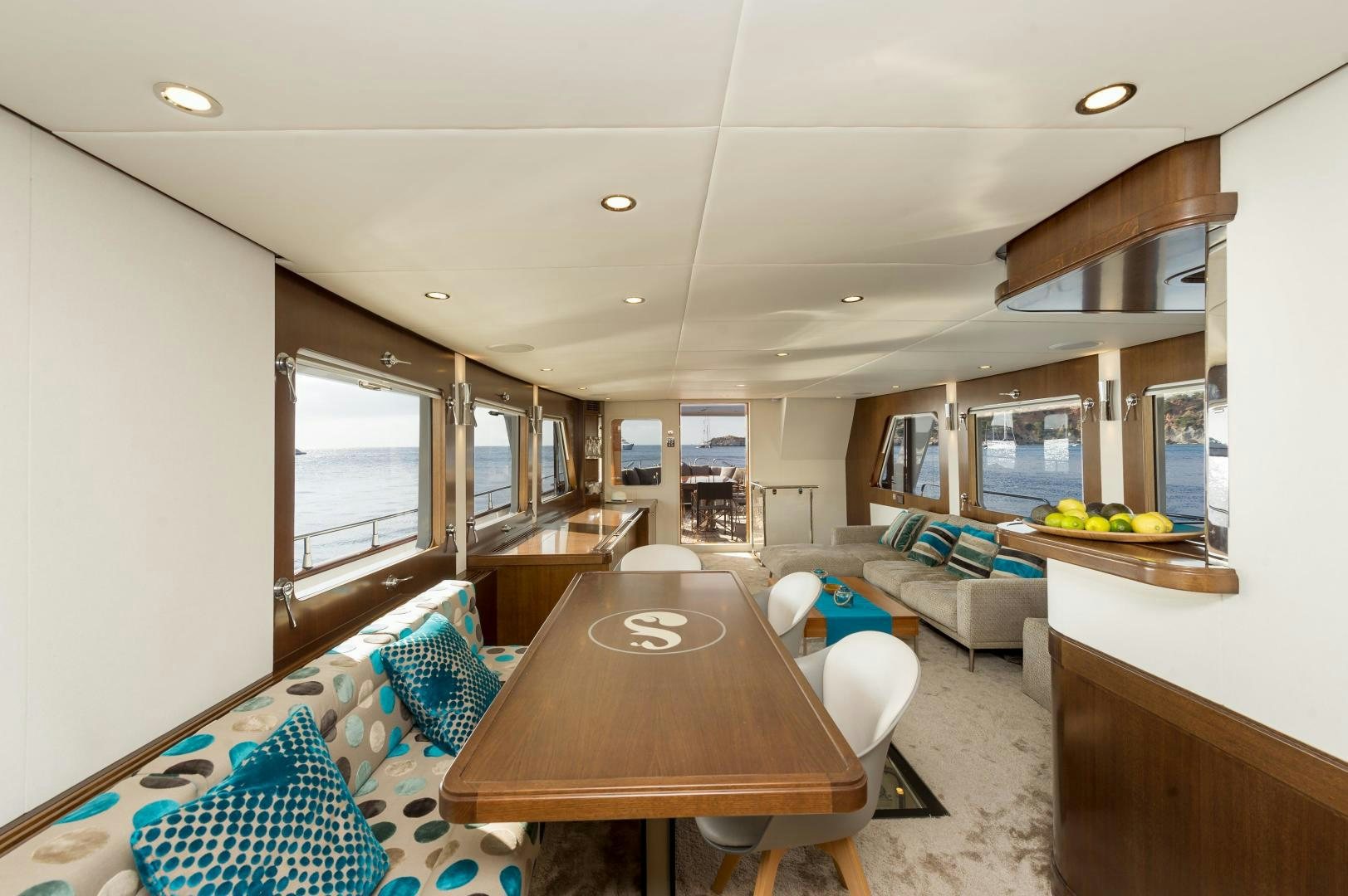 a large living room with a table aboard MONARA Yacht for Sale