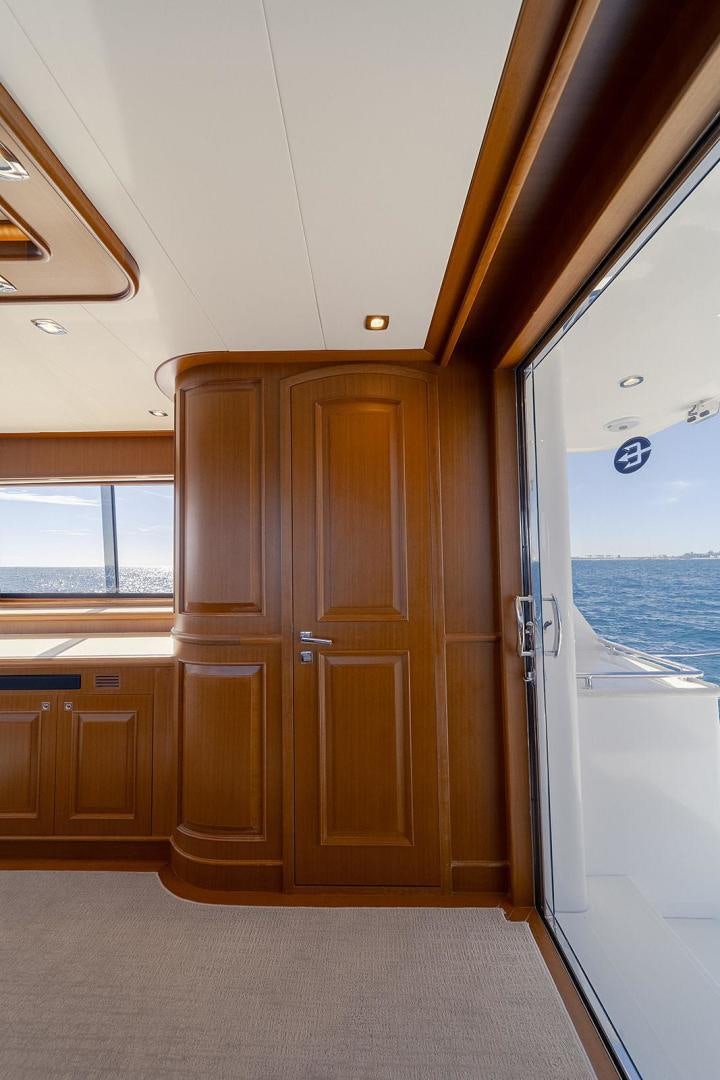 a room with wooden cabinets and a window aboard PARADISE Yacht for Sale