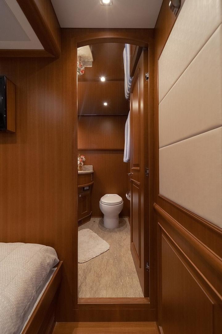 a bathroom with a toilet and a sink aboard PARADISE Yacht for Sale