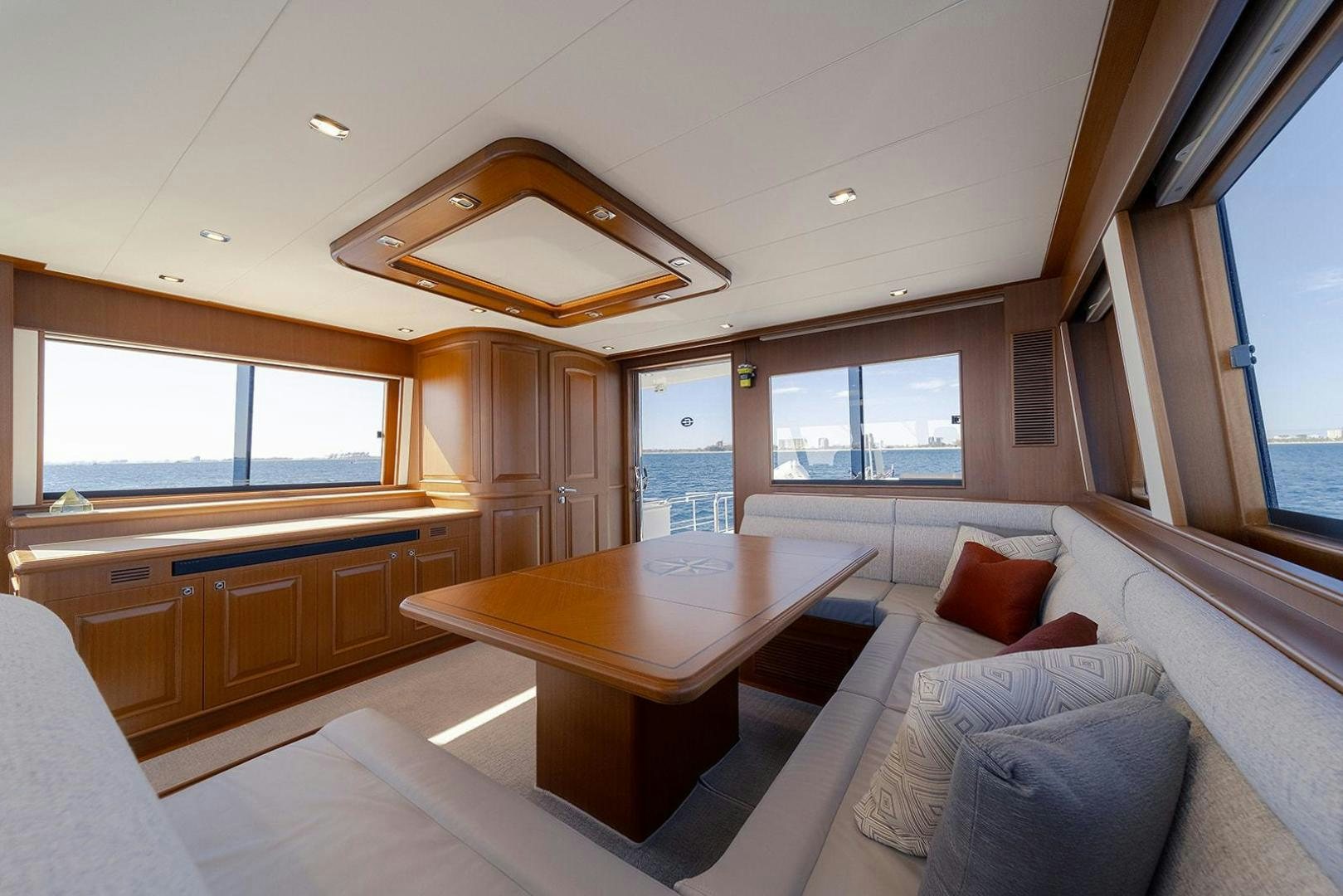 a large living room with a table aboard PARADISE Yacht for Sale