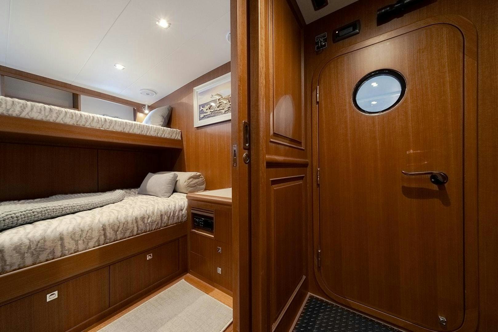 a bedroom with a bed and a closet aboard PARADISE Yacht for Sale