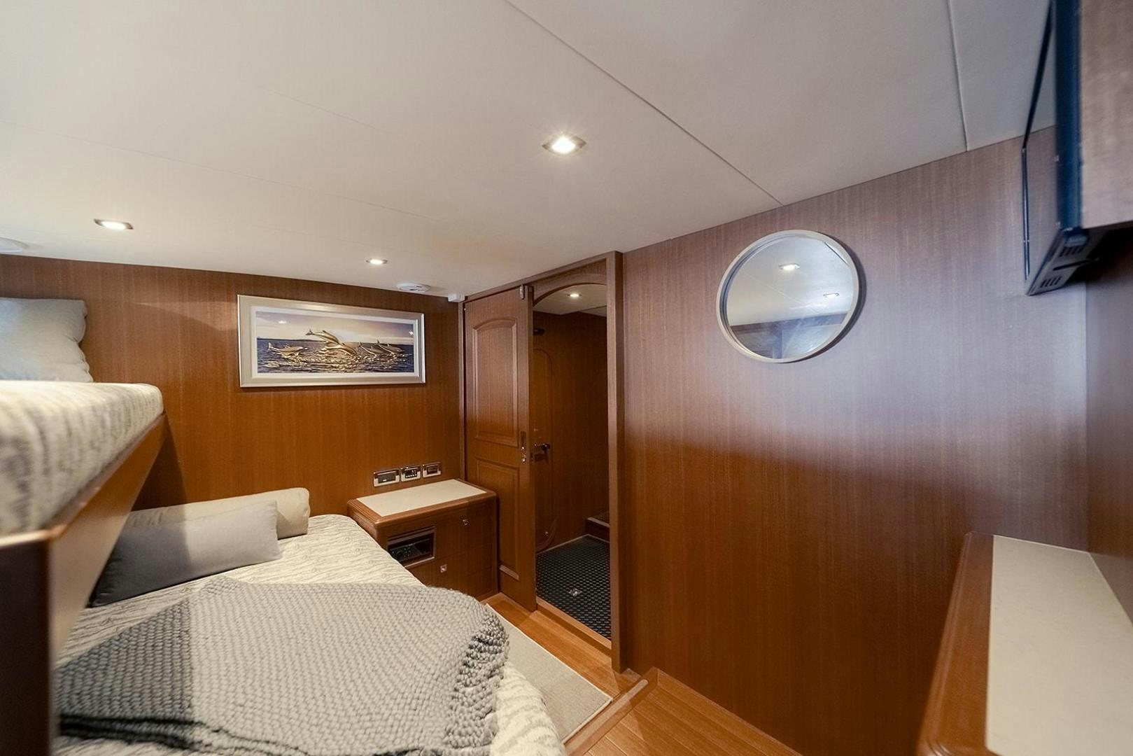 a bedroom with a bed and a mirror aboard PARADISE Yacht for Sale