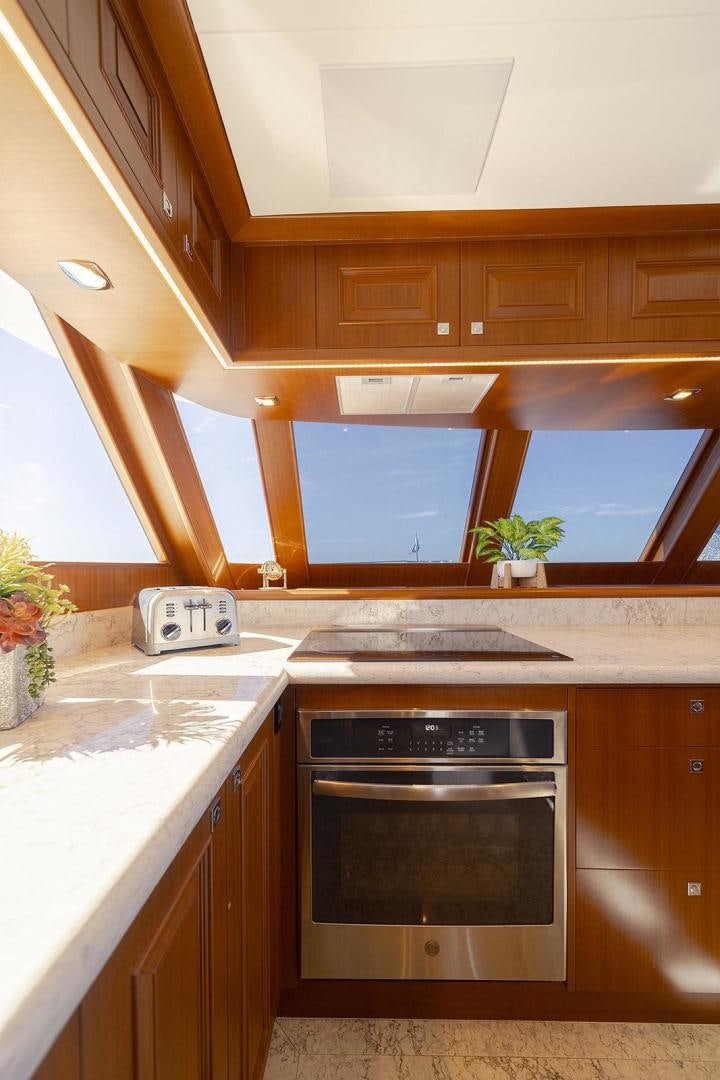 a kitchen with a stove and a sink aboard PARADISE Yacht for Sale