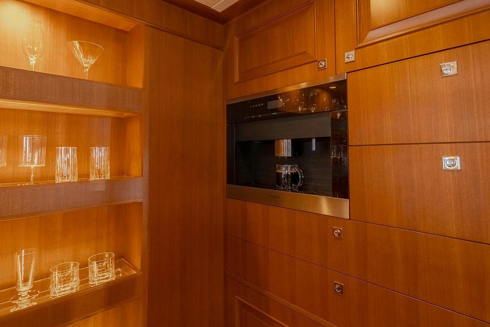 a kitchen with wooden cabinets aboard PARADISE Yacht for Sale