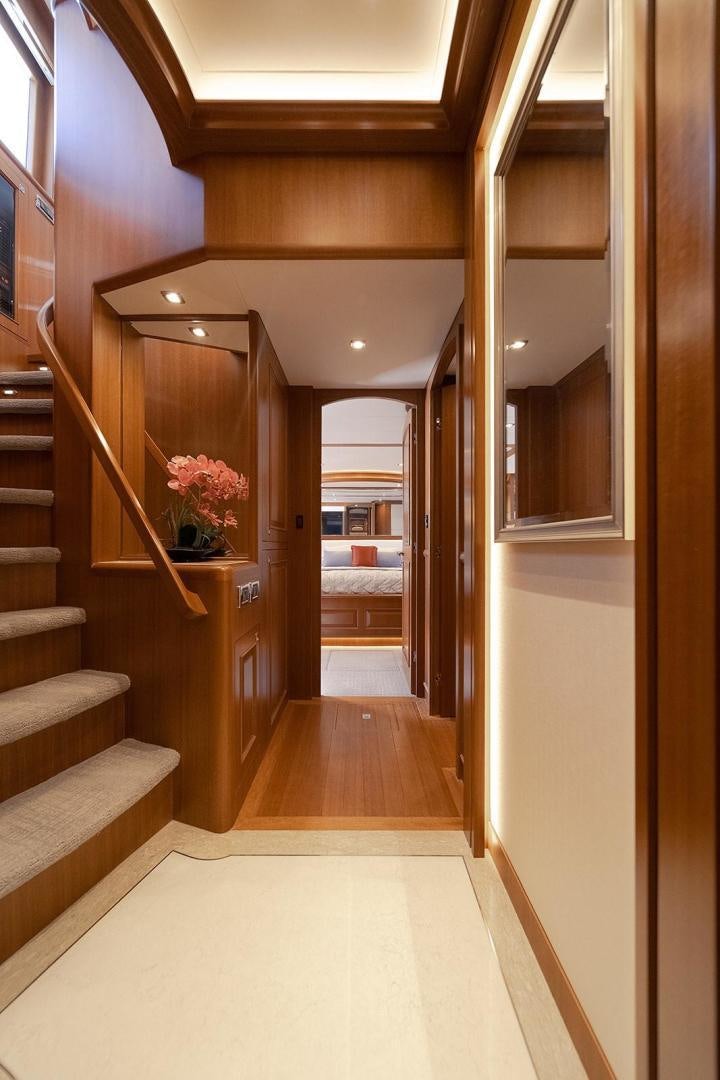 a wooden staircase in a house aboard PARADISE Yacht for Sale