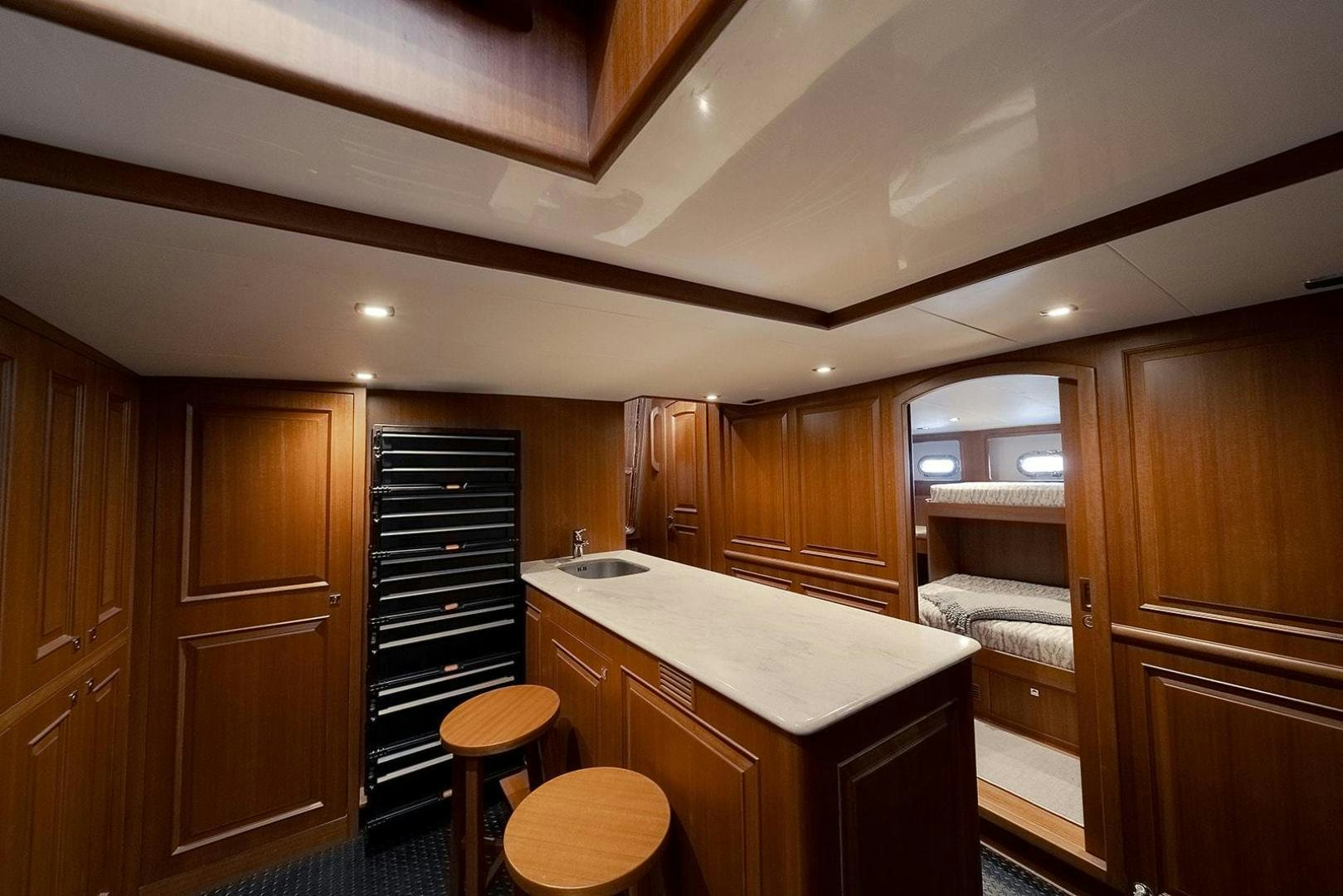 a kitchen with wooden cabinets aboard PARADISE Yacht for Sale