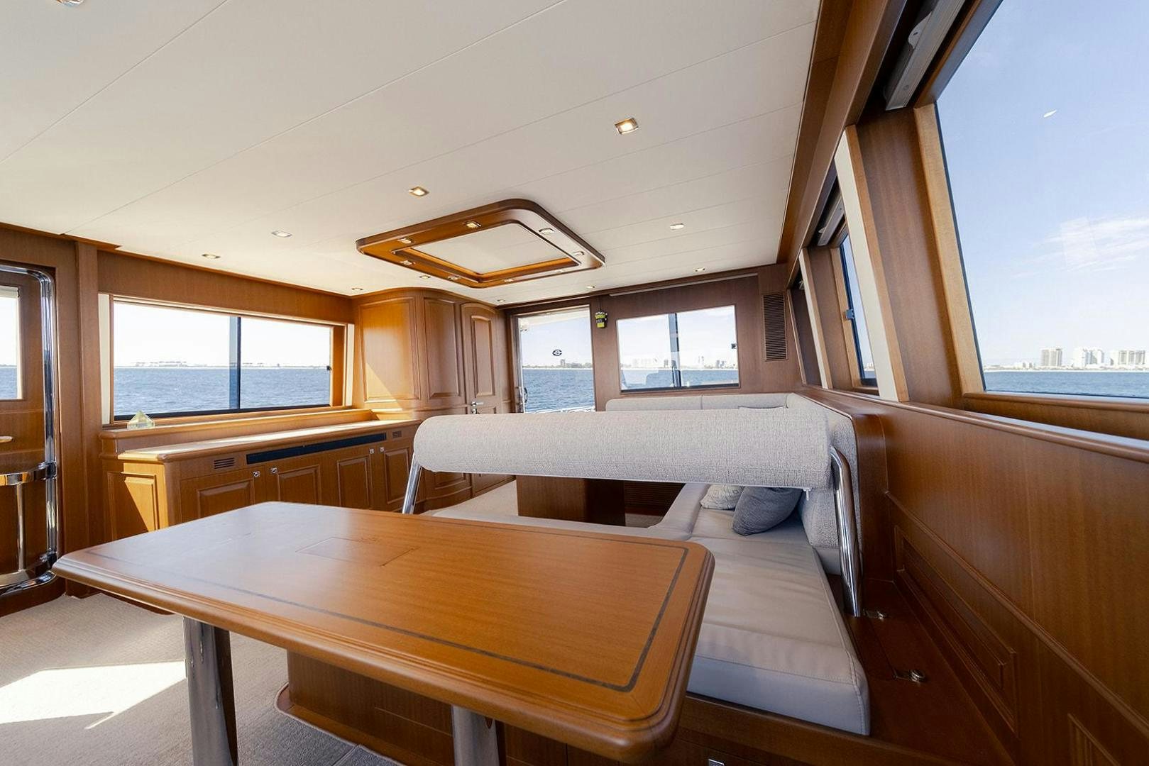 a room with a table and a bed aboard PARADISE Yacht for Sale