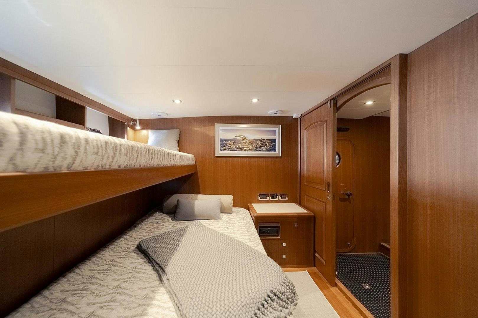 a bedroom with a bed and a closet aboard PARADISE Yacht for Sale