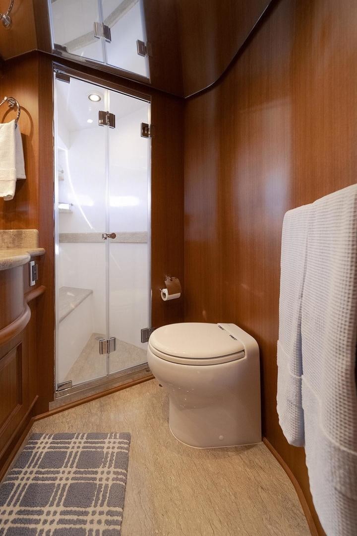 a bathroom with a glass shower door aboard PARADISE Yacht for Sale