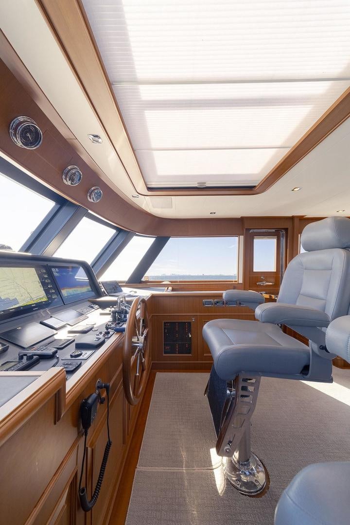 inside of a vehicle with a desk and chairs and computers aboard PARADISE Yacht for Sale