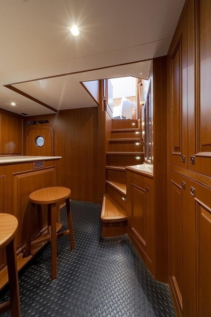 a kitchen with wooden cabinets aboard PARADISE Yacht for Sale