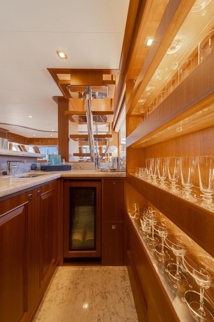 a kitchen with wooden cabinets aboard PARADISE Yacht for Sale