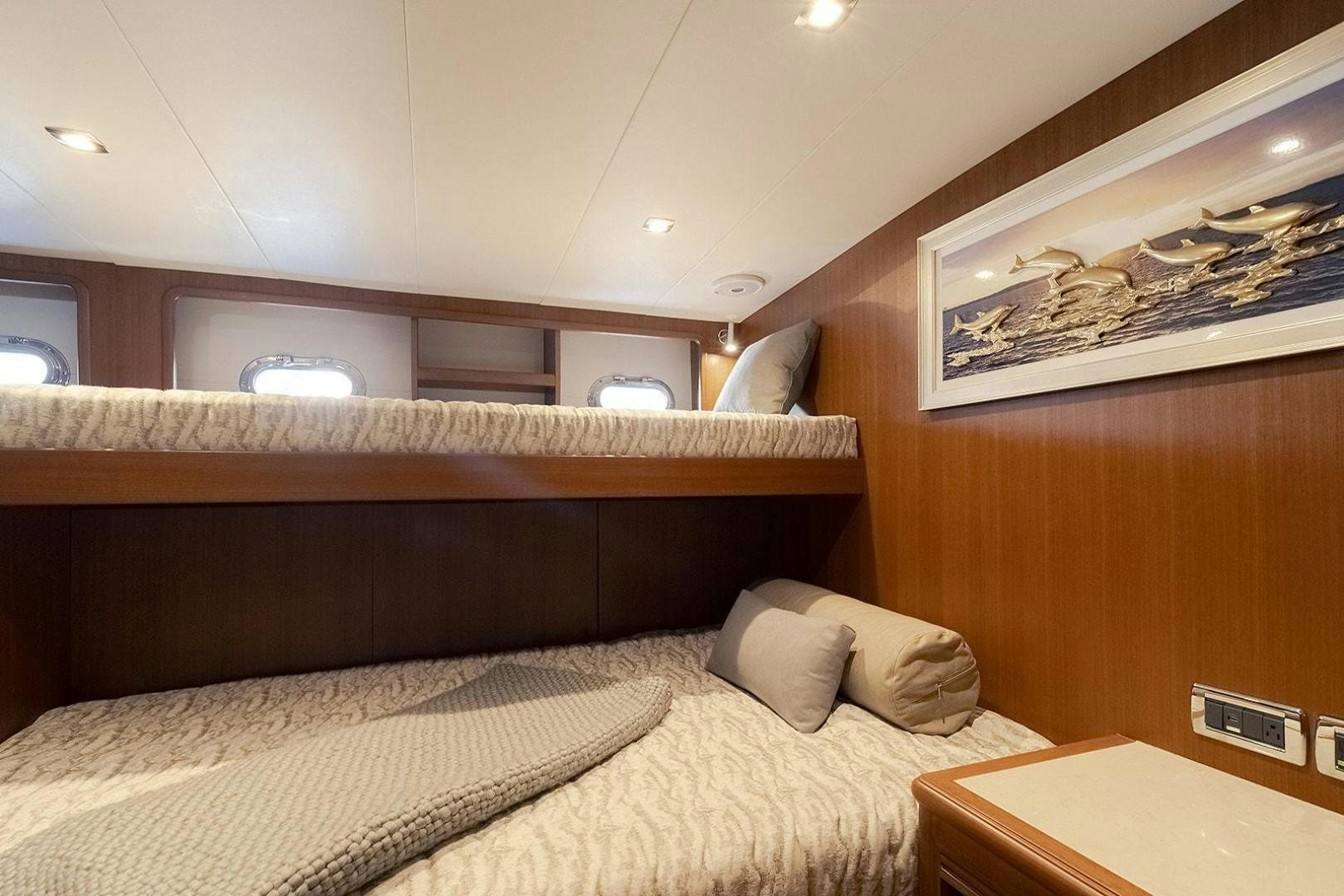 a bed with a wooden headboard aboard PARADISE Yacht for Sale