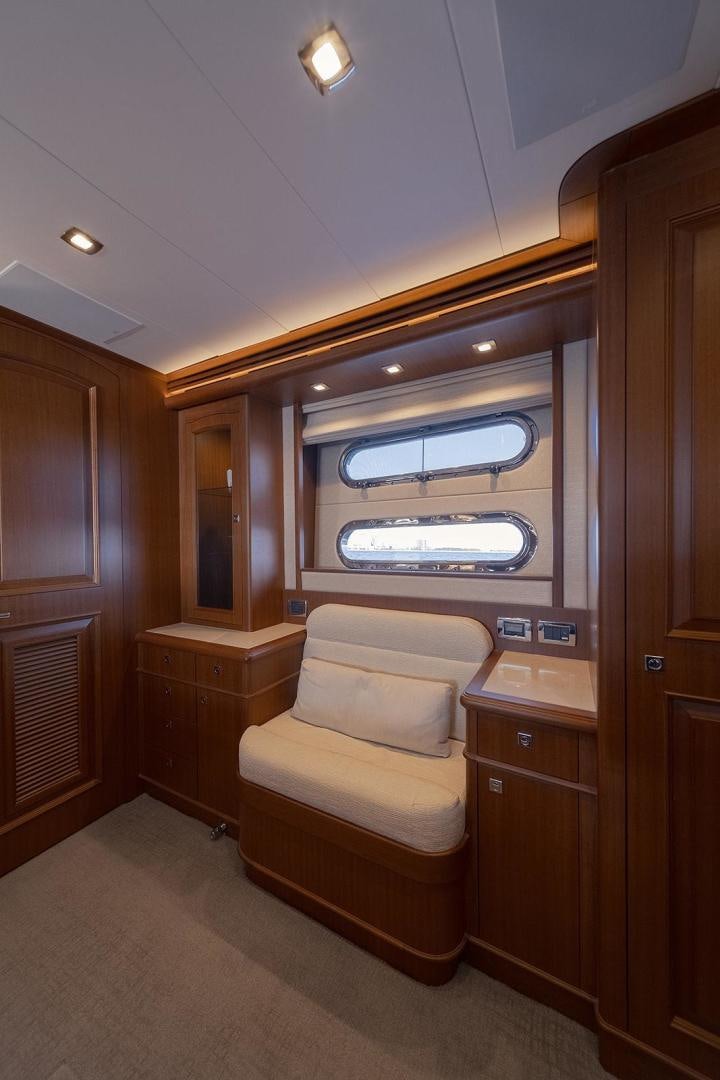 a room with a chair and a window aboard PARADISE Yacht for Sale