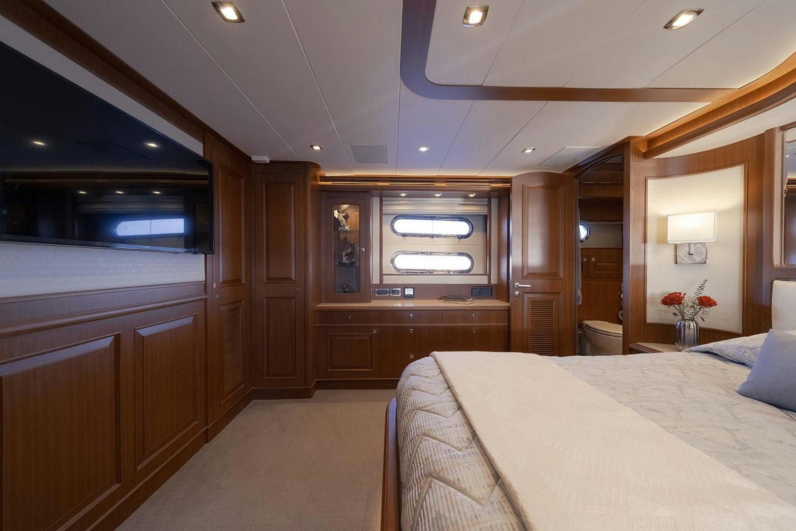 a bedroom with a bed and a closet aboard PARADISE Yacht for Sale