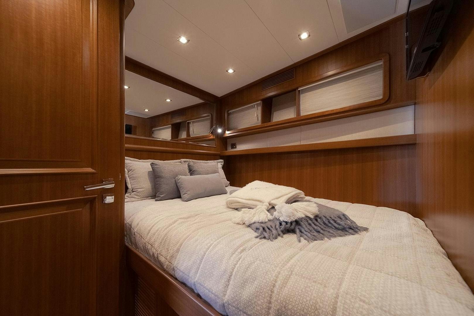 a bed with a white comforter aboard PARADISE Yacht for Sale