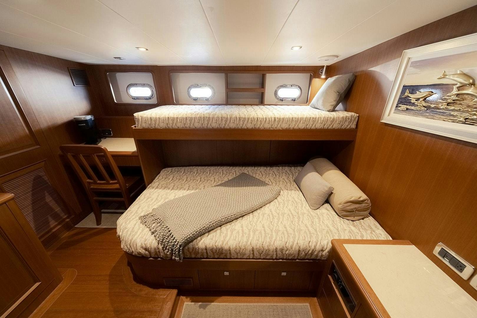 a bed with a wooden frame aboard PARADISE Yacht for Sale