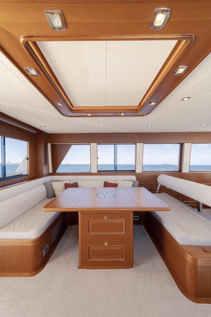 a room with a table and couches aboard PARADISE Yacht for Sale