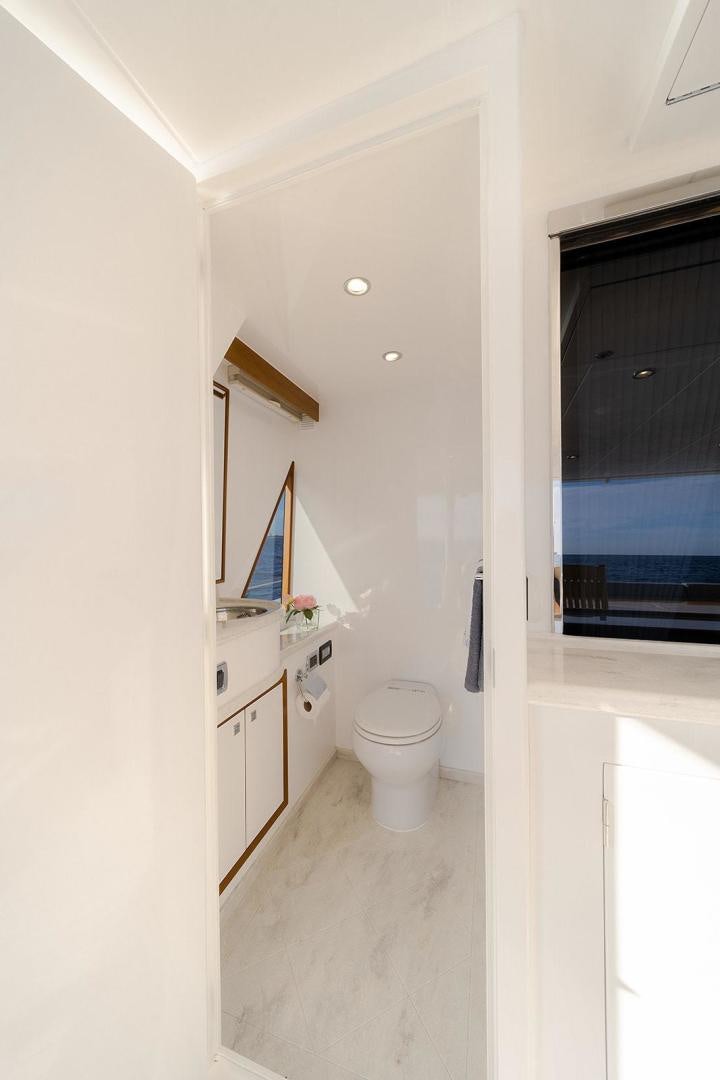 a bathroom with a toilet and a sink aboard PARADISE Yacht for Sale
