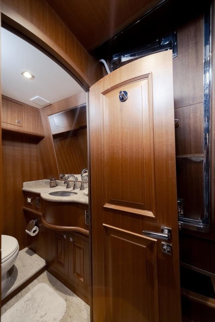 a bathroom with wooden cabinets aboard PARADISE Yacht for Sale