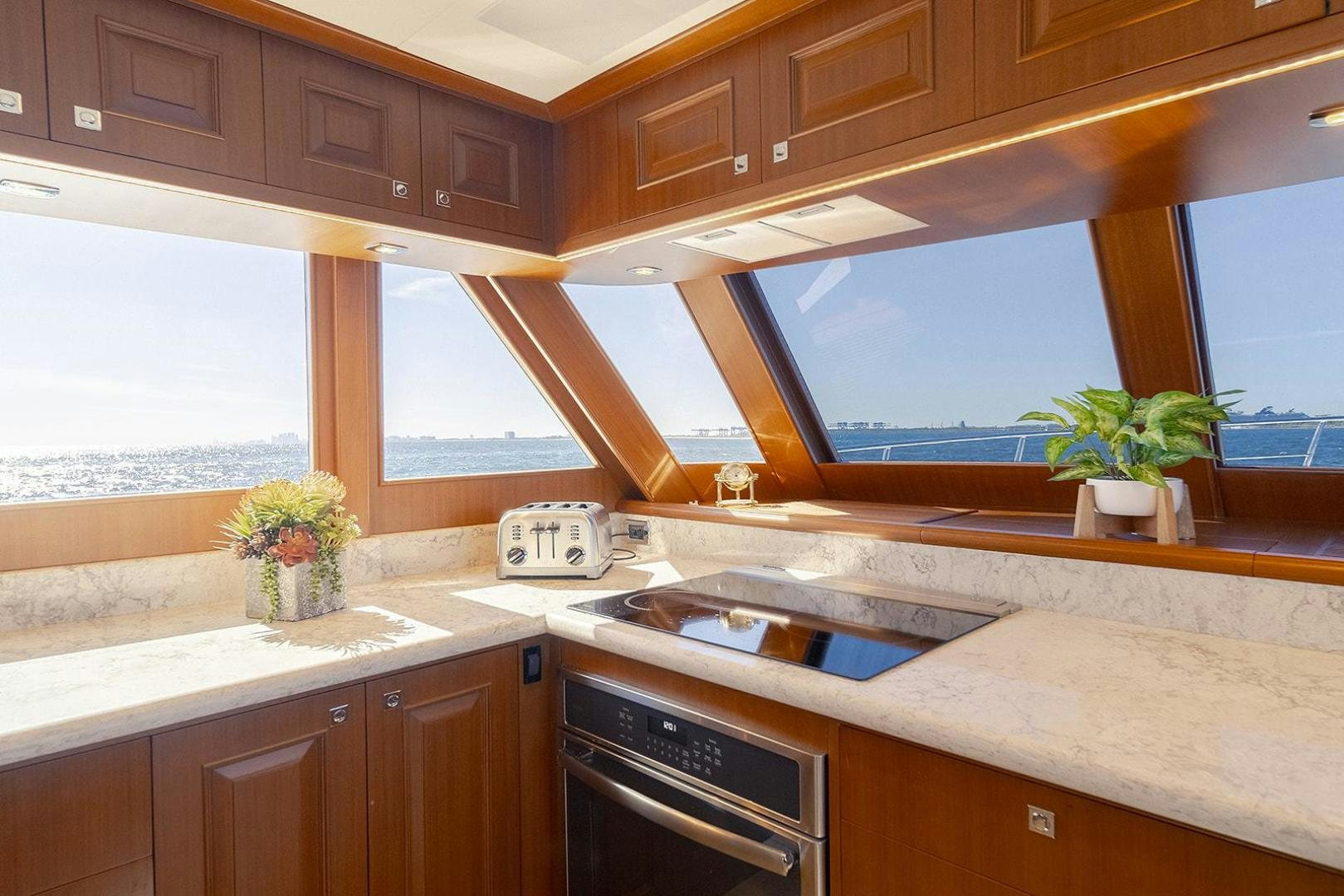 a kitchen with wooden cabinets aboard PARADISE Yacht for Sale