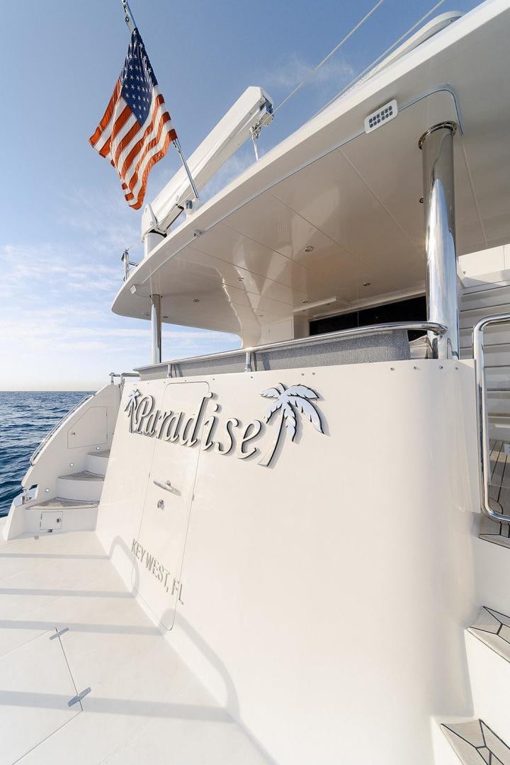 a boat with a flag on the front aboard PARADISE Yacht for Sale