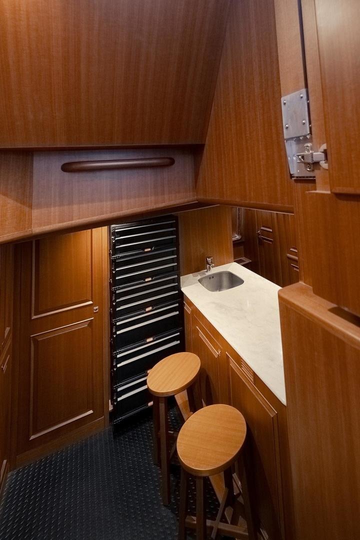 a kitchen with wooden cabinets aboard PARADISE Yacht for Sale