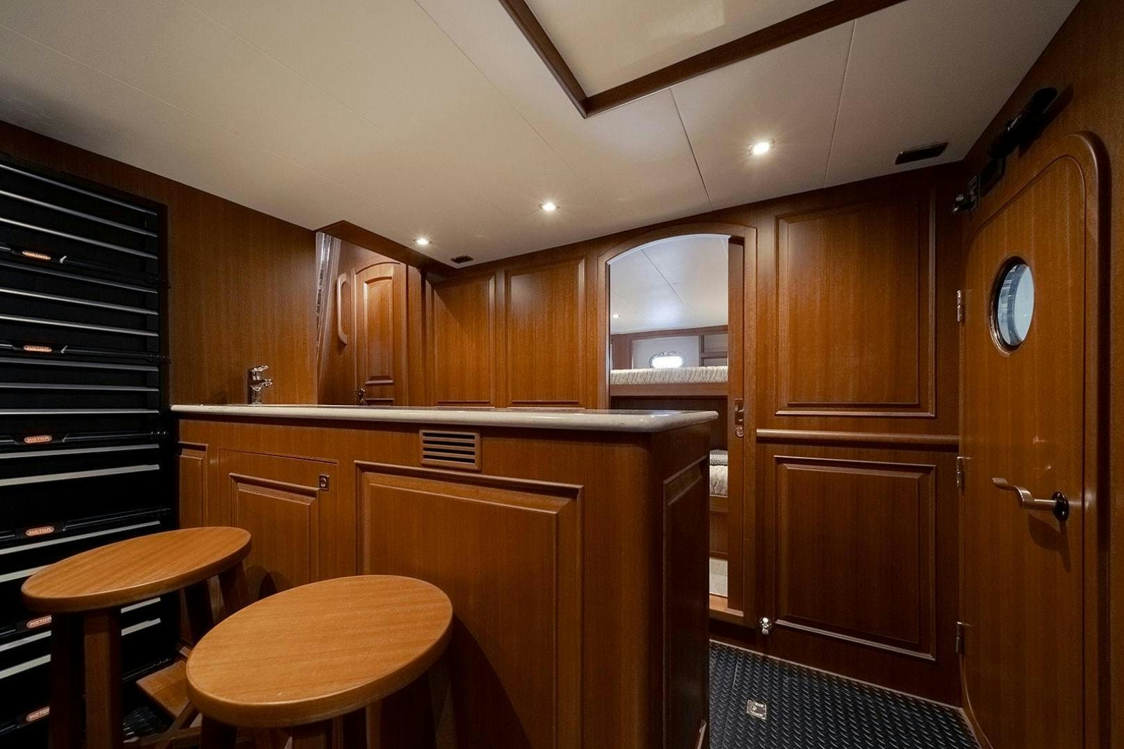 a kitchen with wooden cabinets aboard PARADISE Yacht for Sale
