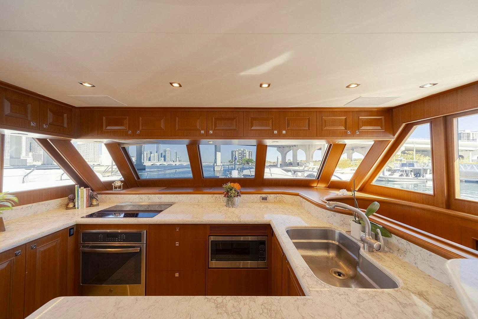 a kitchen with wooden cabinets aboard PARADISE Yacht for Sale