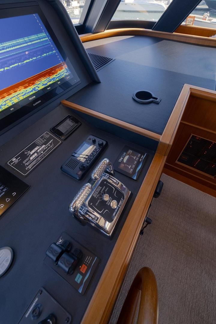 a computer desk with a monitor and a keyboard aboard PARADISE Yacht for Sale
