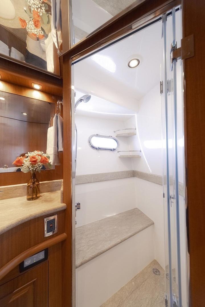 a bathroom with a glass shower aboard PARADISE Yacht for Sale