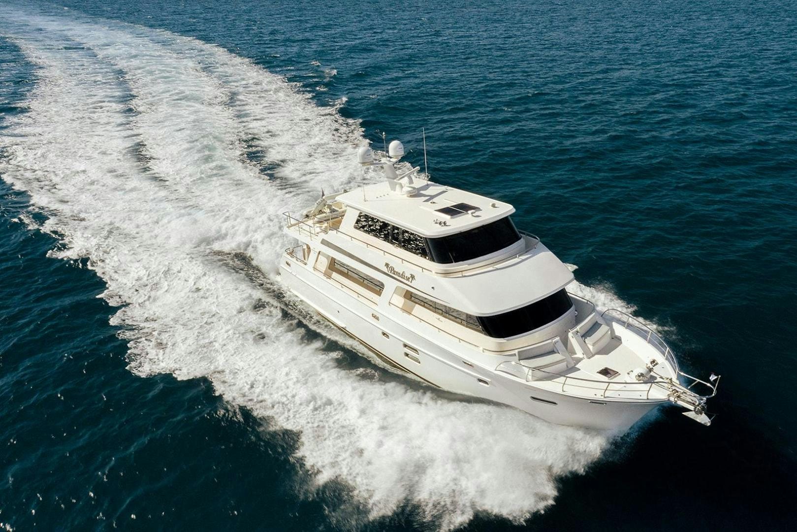 a white boat on the water aboard PARADISE Yacht for Sale