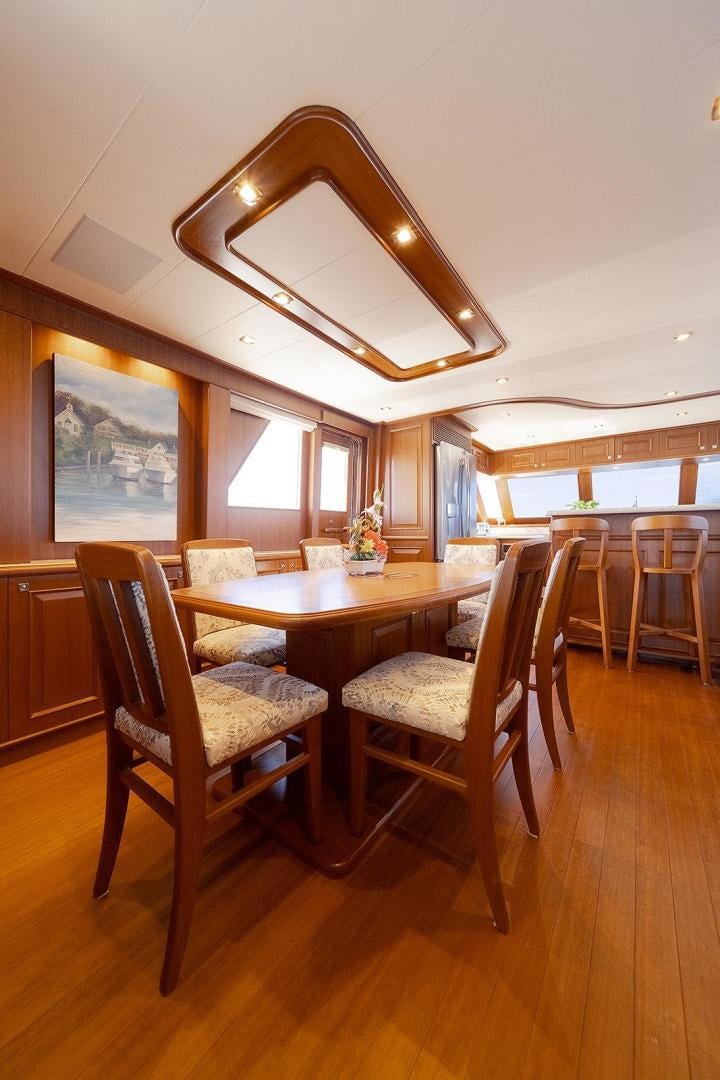 a dining room with a table and chairs aboard PARADISE Yacht for Sale