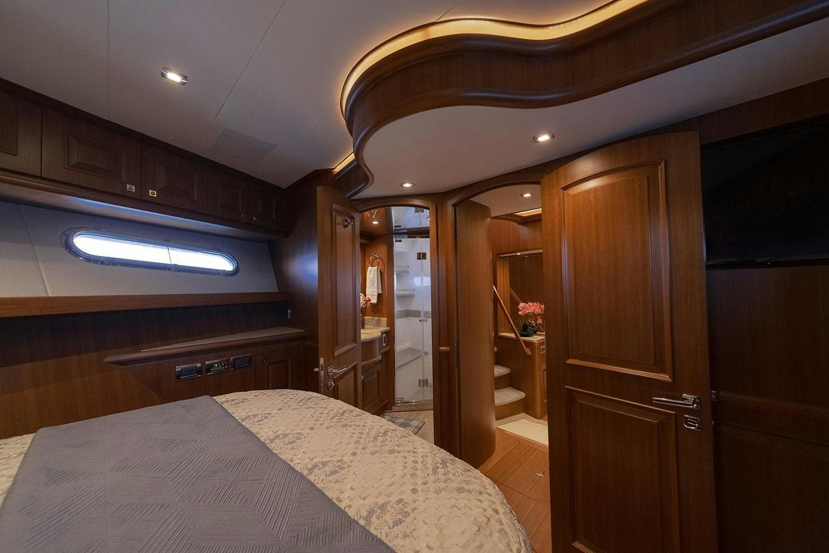 a bedroom with a bed and a closet aboard PARADISE Yacht for Sale