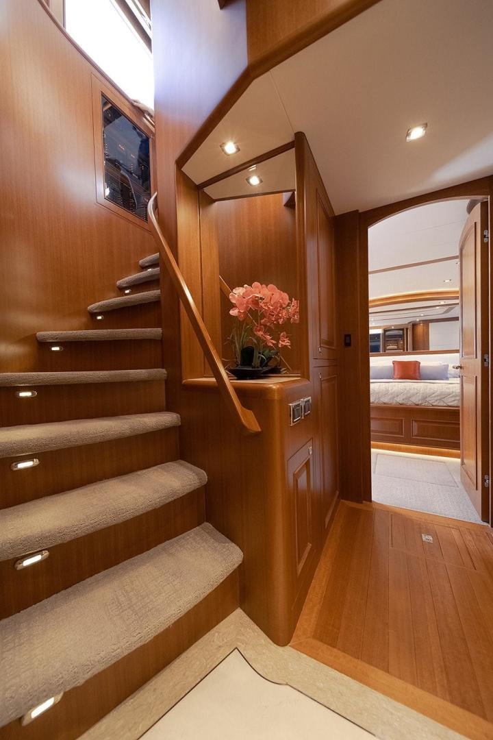 a wood staircase with a flower on the side aboard PARADISE Yacht for Sale
