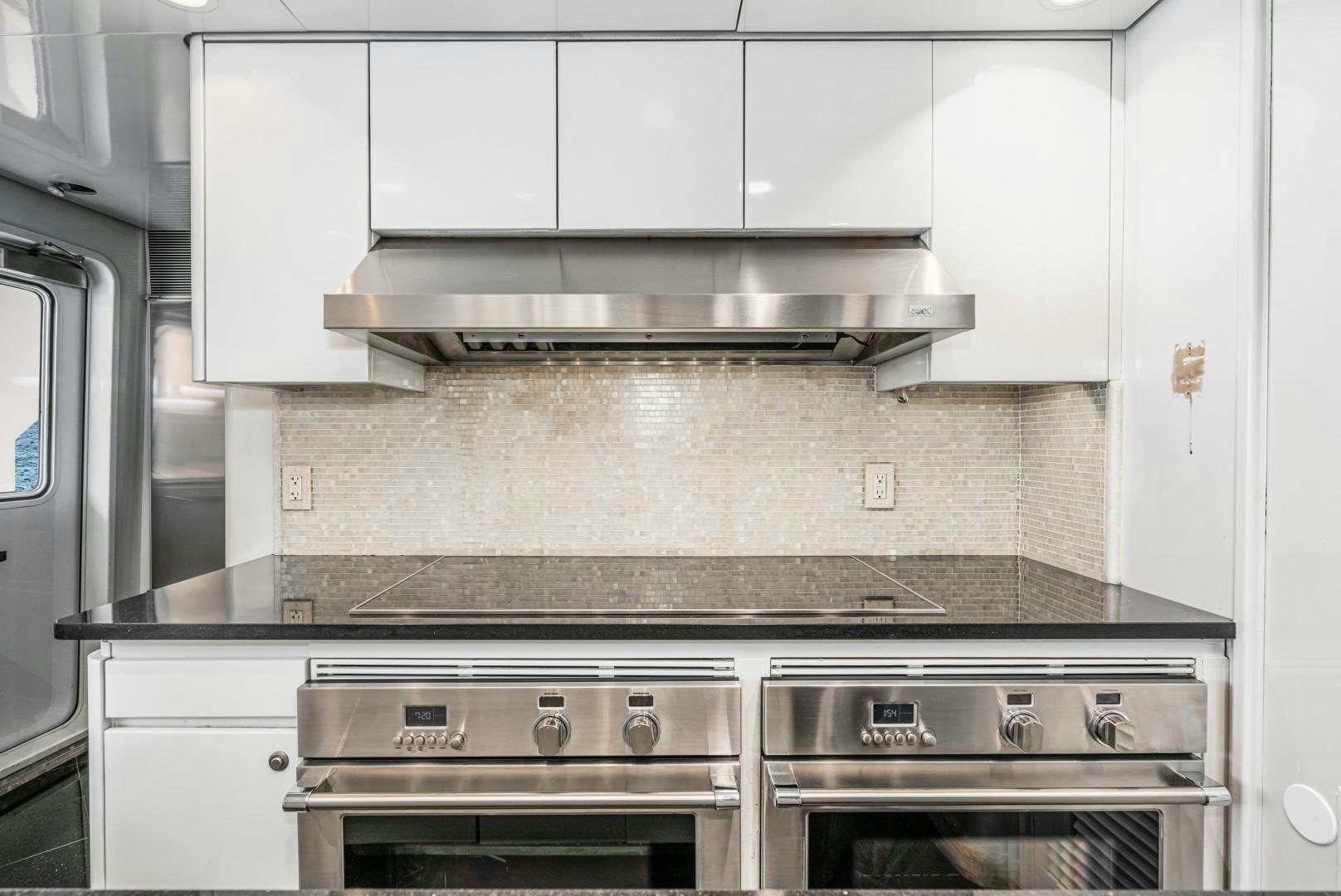 a kitchen with white cabinets aboard AFTERGLOW Yacht for Sale
