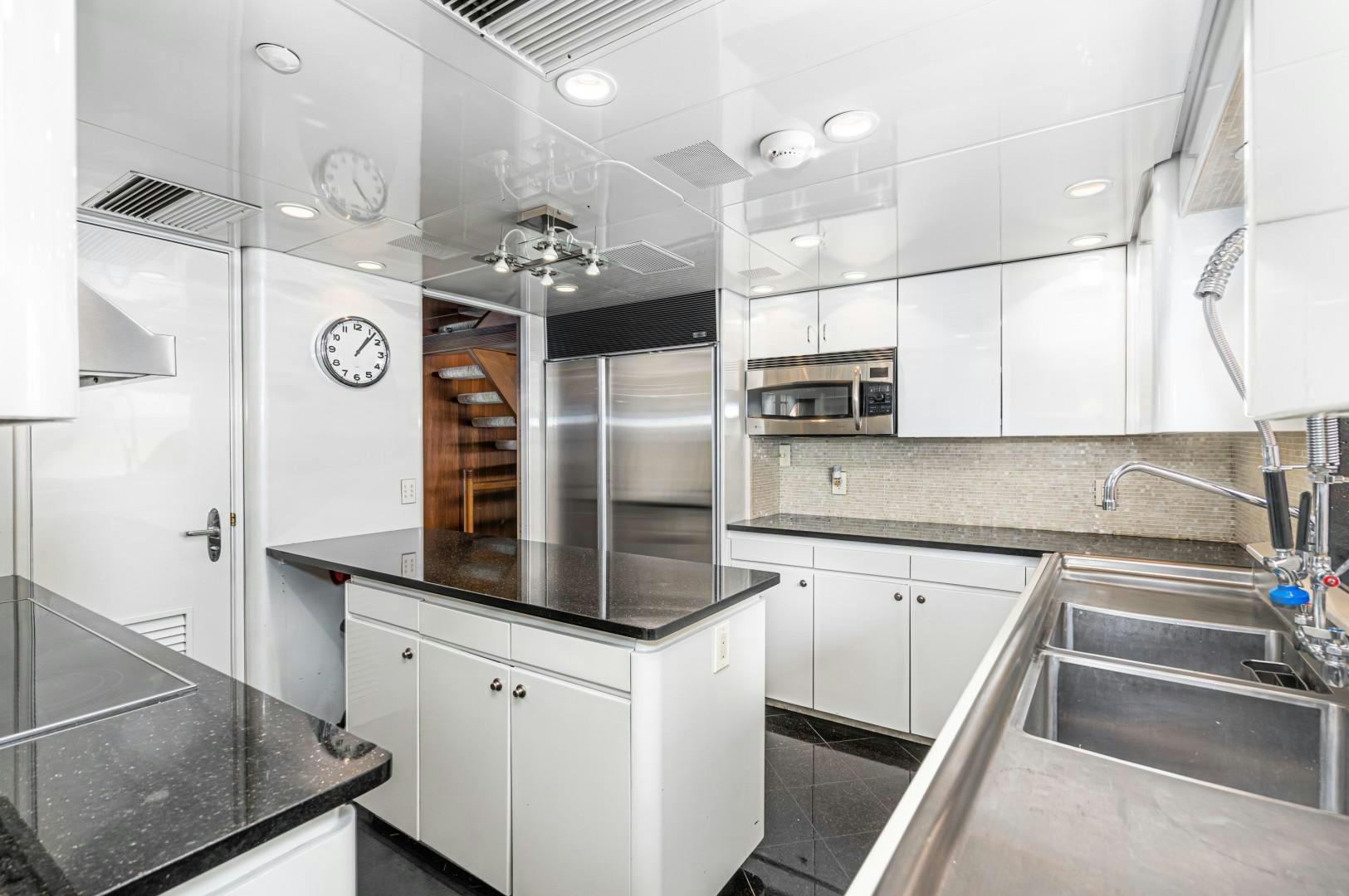 a kitchen with white cabinets aboard AFTERGLOW Yacht for Sale