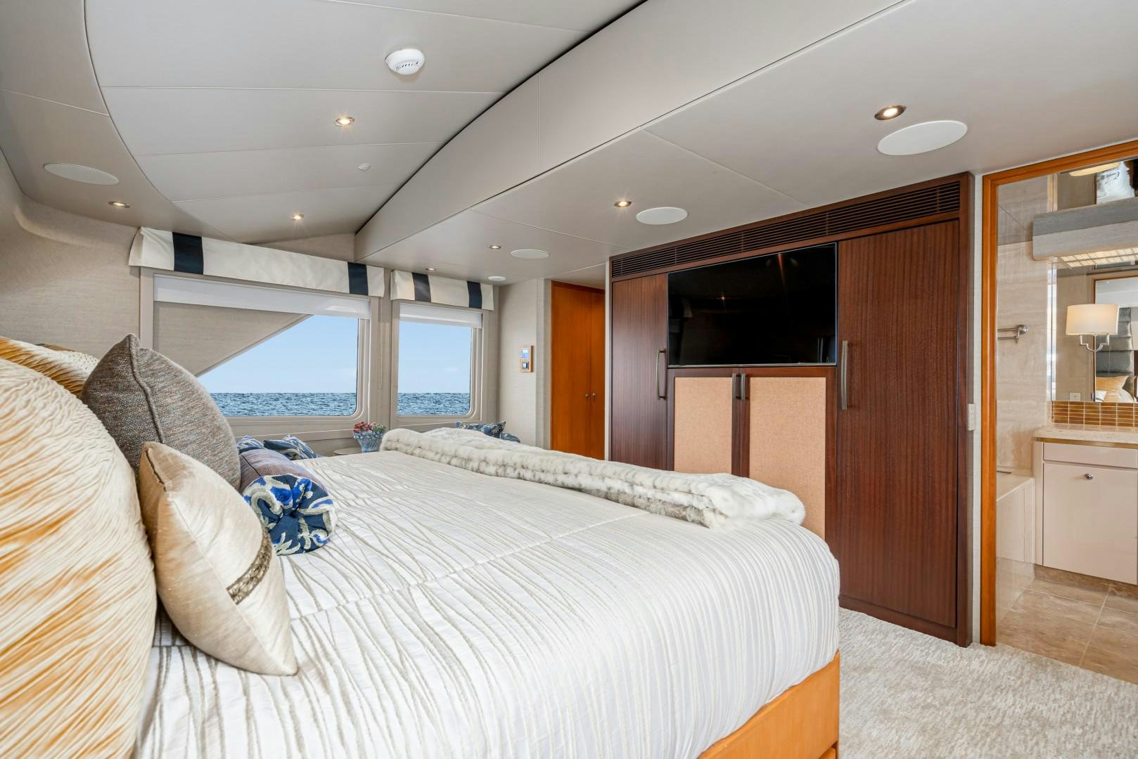 a bedroom with a bed and a television aboard AFTERGLOW Yacht for Sale
