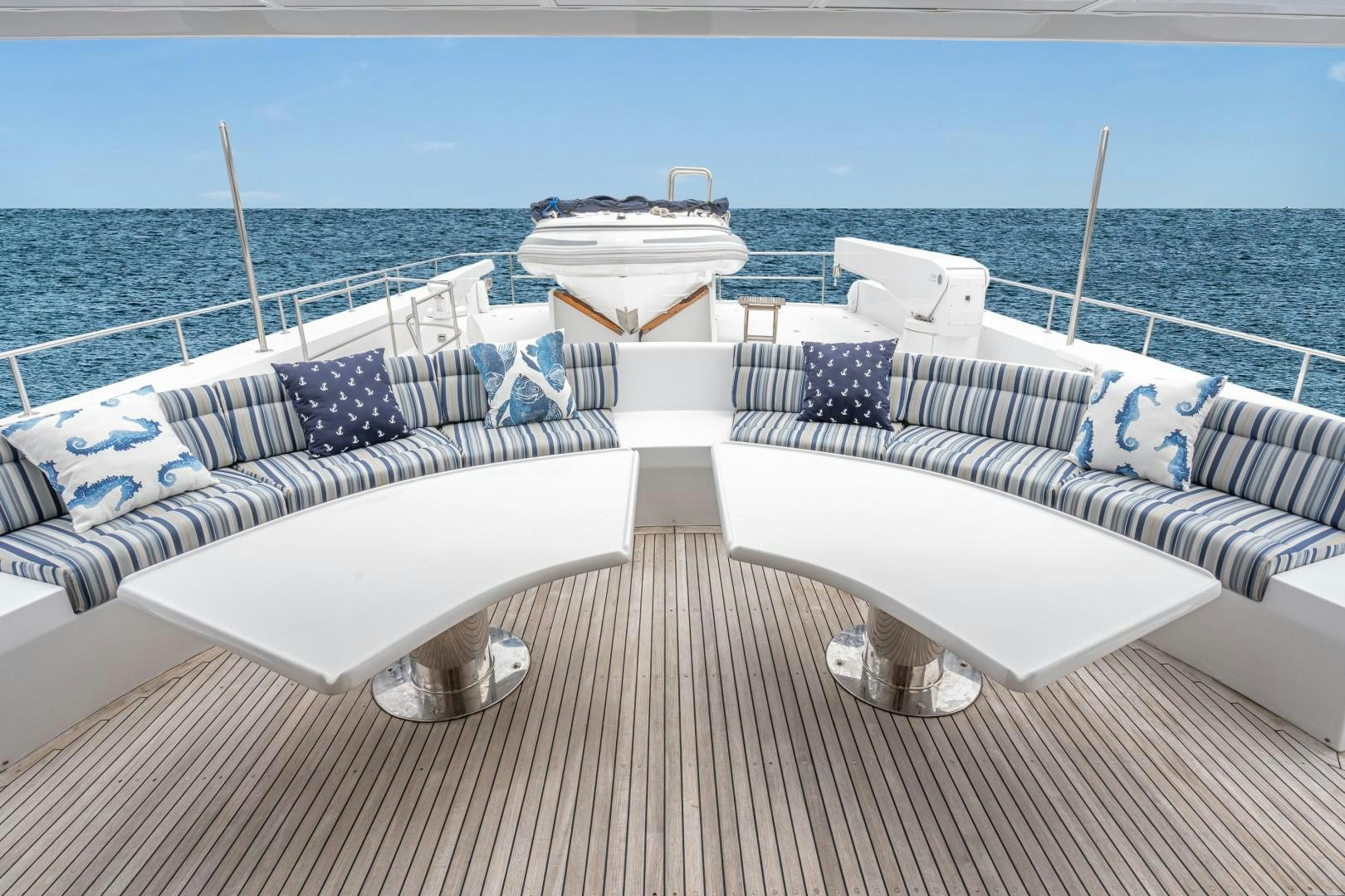 a deck with chairs and a boat on it aboard AFTERGLOW Yacht for Sale