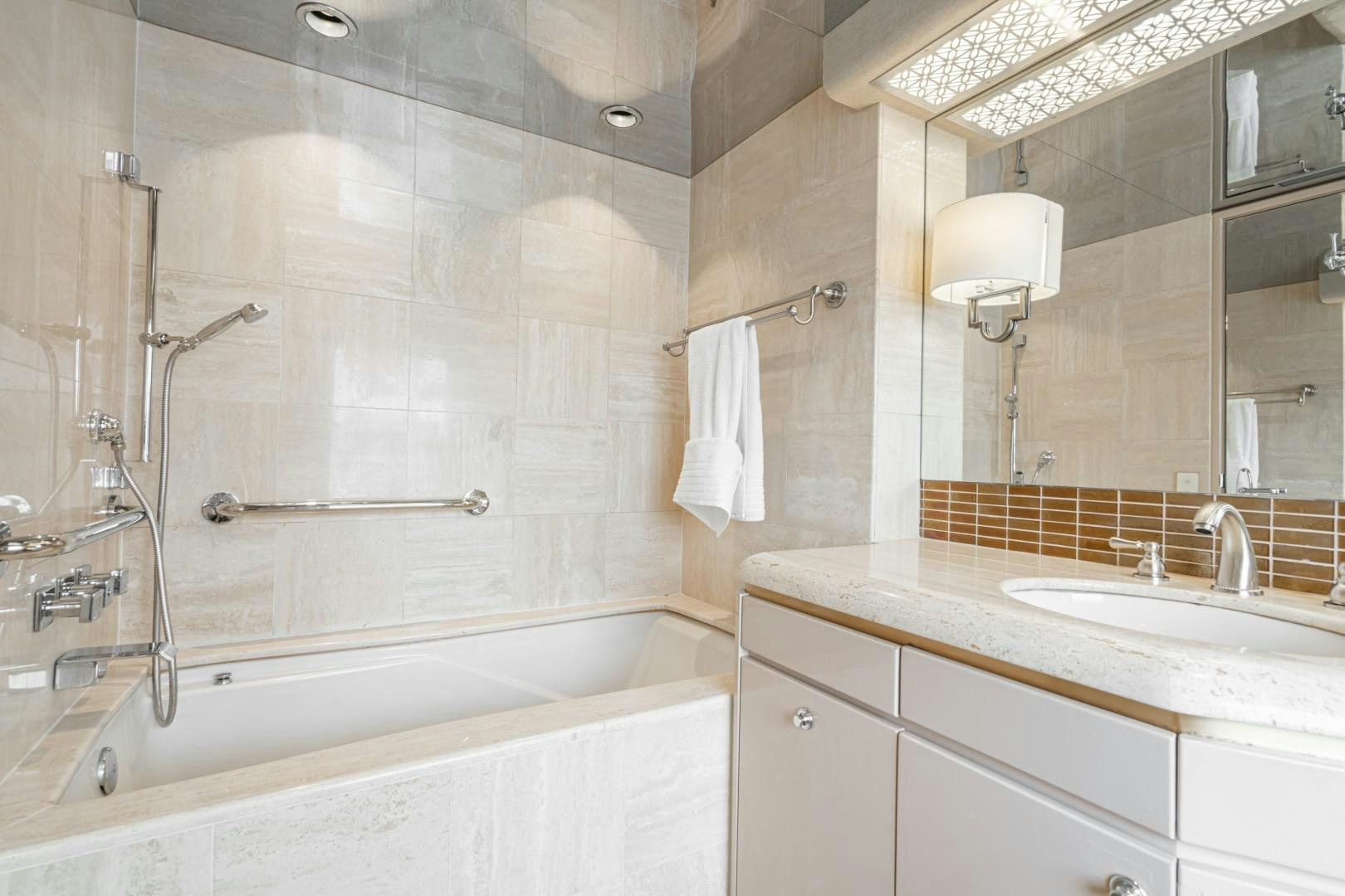 a bathroom with a bathtub sink and a mirror aboard AFTERGLOW Yacht for Sale