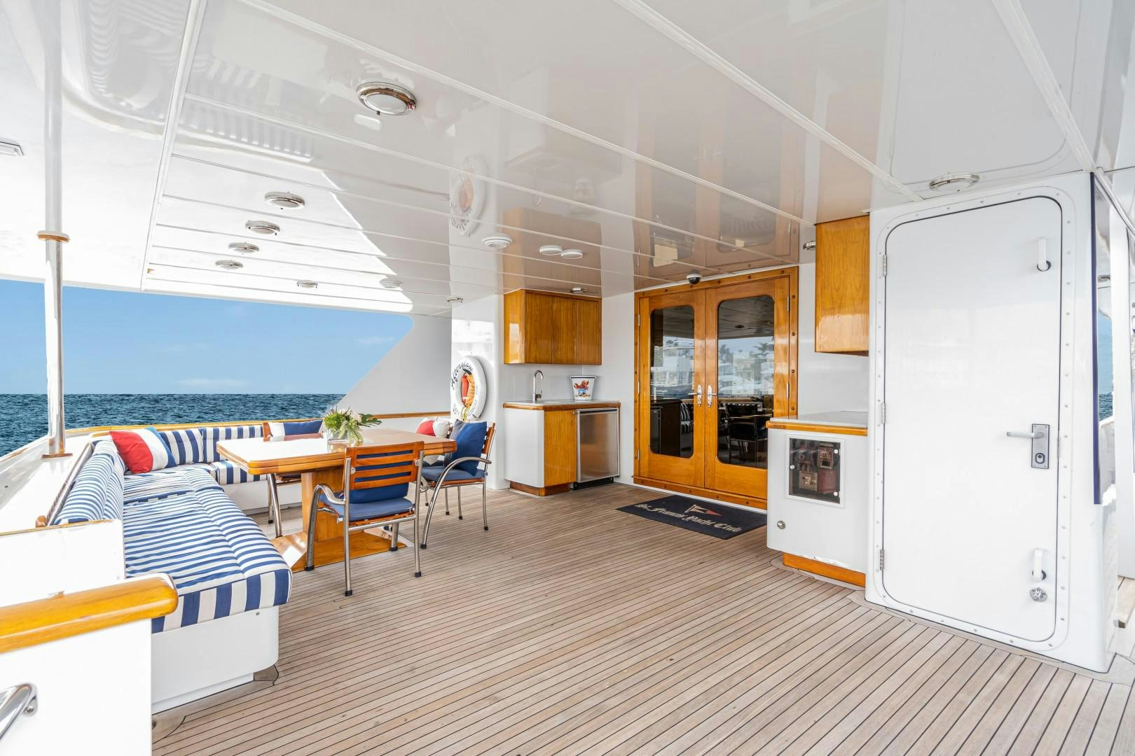 a room with a table chairs and a large window aboard AFTERGLOW Yacht for Sale