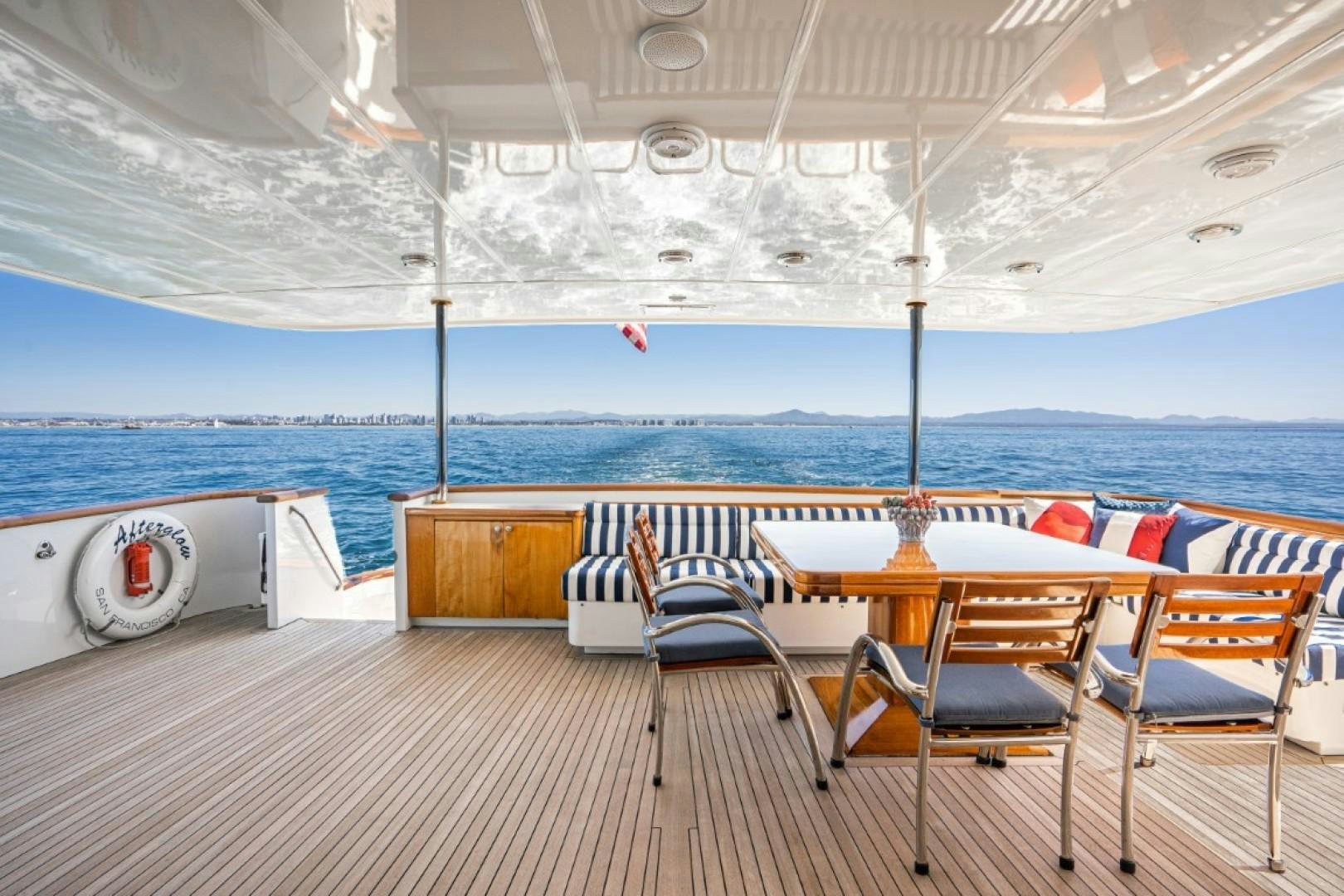 a deck with chairs and tables on it aboard AFTERGLOW Yacht for Sale