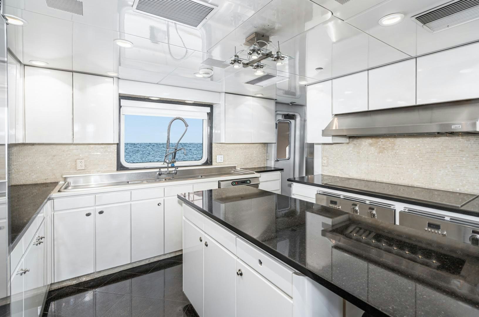 a kitchen with white cabinets aboard AFTERGLOW Yacht for Sale